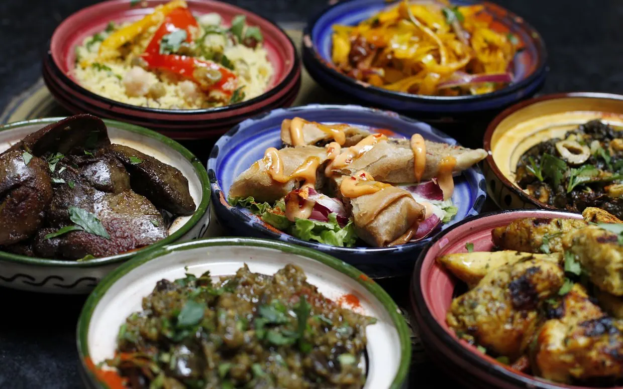 A table of Moroccan mezze and tagines ready to share
